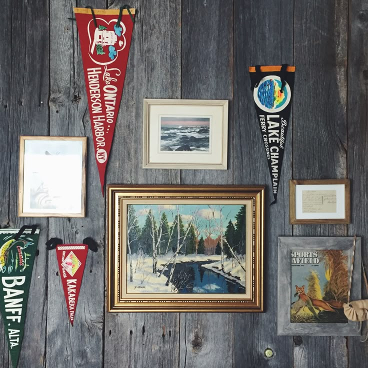 a wall with pictures and pennants hanging on it