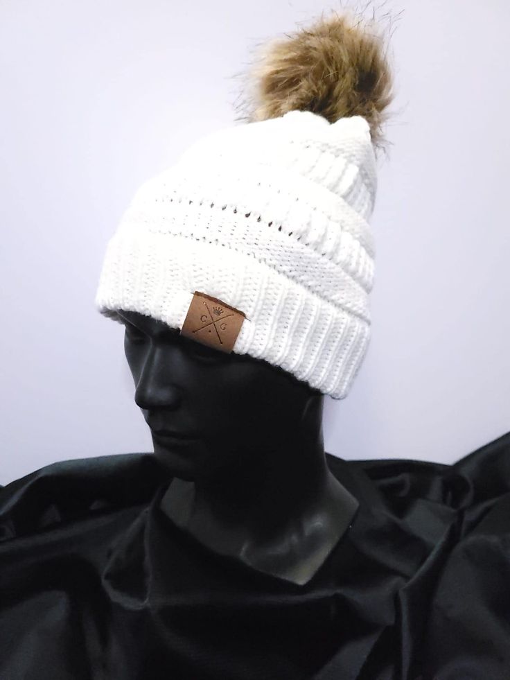 Satin-lined winter hat with tan pom, with signature red satin lining. Pom is not removable. Available in both white and black. Protect your curls this winter! White Winter Hat With Faux Fur Lining, White Hat With Faux Fur Lining For Winter, Casual White Hat For Fall, White Winter Beanie One Size, Trendy White Beanie One Size, Trendy Fitted White Beanie, Trendy Warm White Beanie, White Winter Hats For Cold Weather, White Winter Beanie Cap