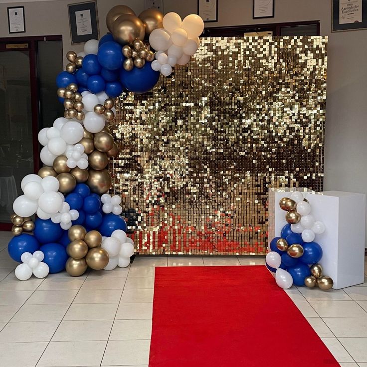 a red carpet and some white and blue balloons