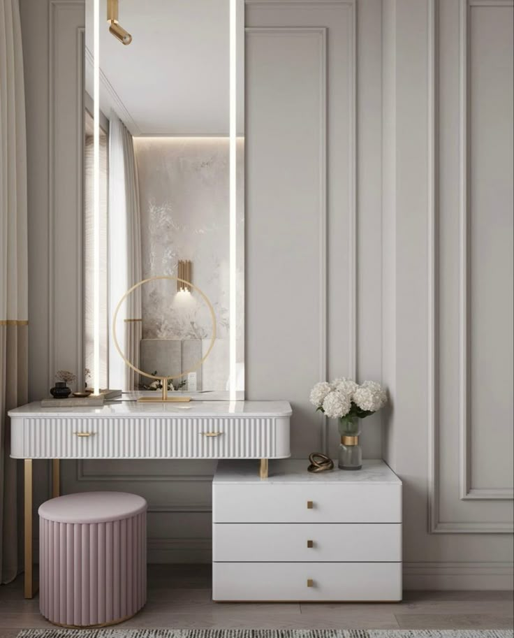 a white dressing table with a mirror and stool