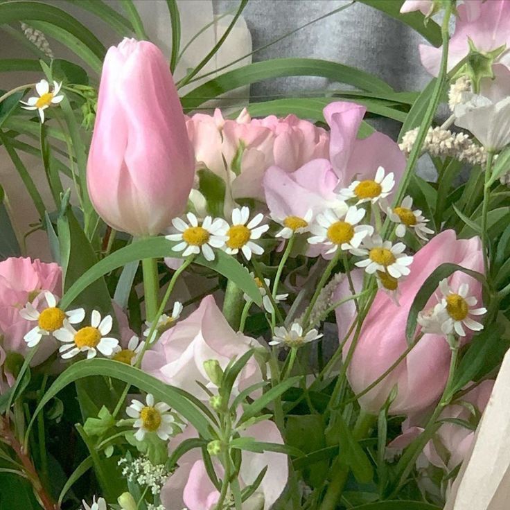 pink and white flowers are in a vase