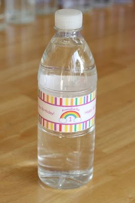 a bottle of water sitting on top of a wooden table