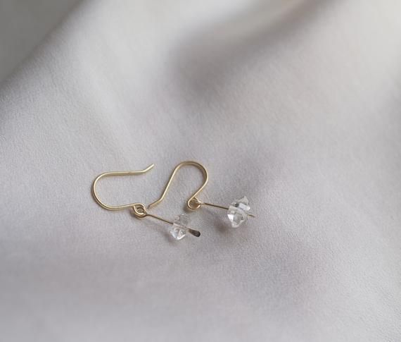 These dainty earrings are a cute way to add a little subtle sparkle to your look! Elegant and understated crystal earrings, but with a raw feel to them. The clean design of these earrings makes them really classy and versatile. Each earring contains a teeny floating Herkimer diamond. Herkimer diamonds are mined from a specific mine from New York State and are known by the double termination (pointy on both sides of the crystal) They are held in a little drop of brass, hammered for a rough textur Minimalist Sterling Silver Crystal Earrings, Dainty Hypoallergenic Crystal Earrings For Everyday, Minimalist Nickel-free Dangle Crystal Earrings, Minimalist Nickel Free Drop Crystal Earrings, Minimalist Dangle Crystal Earrings With Ear Wire, Minimalist Crystal Drop Earrings With Ear Wire, Minimalist Crystal Earrings With Ear Wire For Gift, Minimalist Sterling Silver Crystal Earrings For Everyday, Minimalist Dangle Crystal Earrings