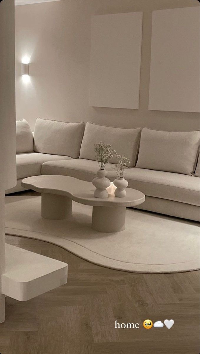 a modern living room with white furniture and wood flooring