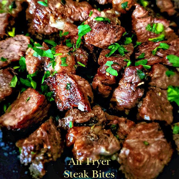 steak bites with parsley on top in a skillet, ready to be eaten