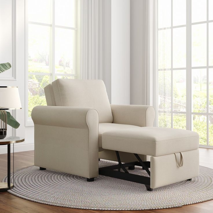 a living room with a chair and ottoman