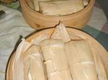 two wooden bowls filled with food sitting on top of a table next to each other