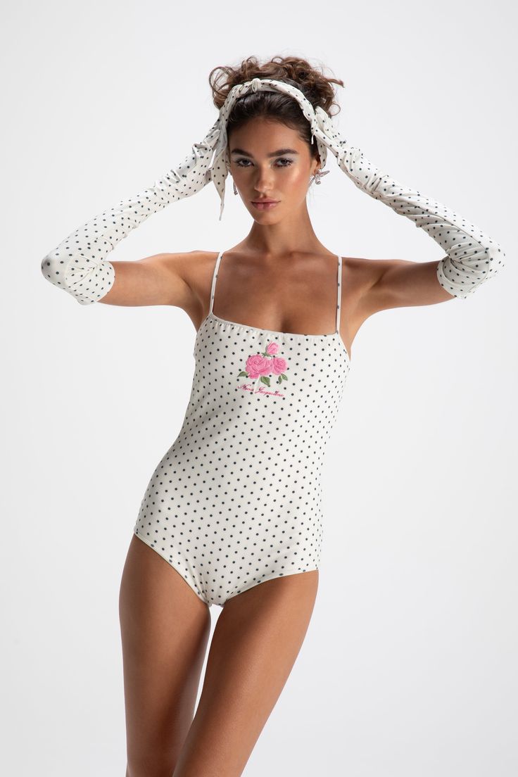 THIS ITEM IS FINAL SALE AND NOT ELIGIBLE FOR A RETURN OR EXCHANGE Fall in love with this retro swim set. The Lola Bodysuit and Gloves are a match-made in heaven with the beautiful dot print and sexy silhouette. The cross design in the back sits perfectly on the body while the special embroidery on the front adds a unique flair. Wear them together for a whole vibe. Polka dot swimsuit and gloves Brocade ammonia fabric Cross design Dry clean only Fitted Retro Swimwear For Pool, Retro Fitted Swimwear For Poolside, White Retro Swimwear For Sunbathing, Retro White Swimwear For Pool, Retro Party Swimwear For Beach Season, Chic White Lined Swimwear, Retro Summer Swimwear With Lined Body, Retro Swimwear With Lined Body For Summer, Retro Party Swimwear Fitted