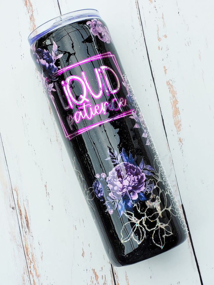 a black can with purple flowers on it and the words loud nature written in pink