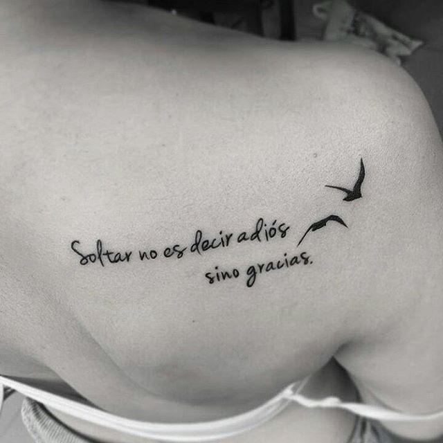 the back of a woman's shoulder with an inscription on it