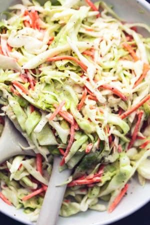 a white bowl filled with coleslaw and carrots