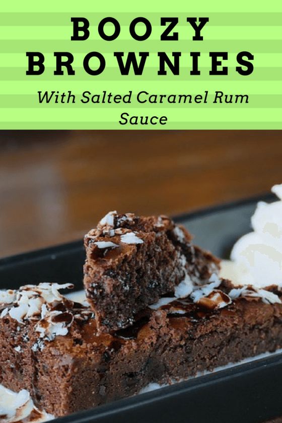 chocolate brownies with salted caramel rum sauce in a black tray on a wooden table