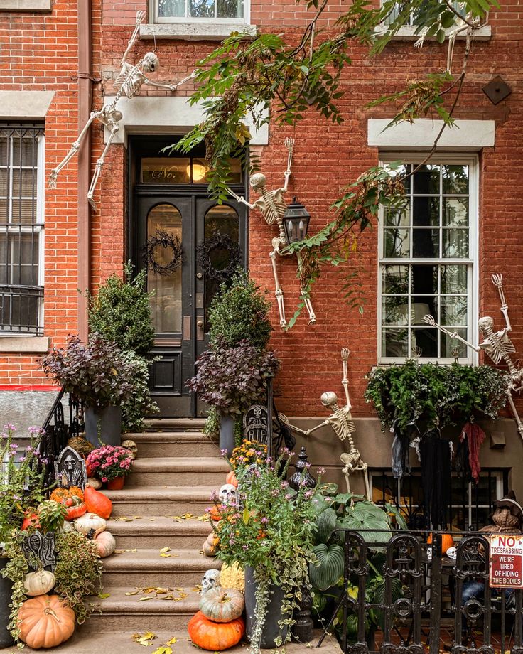 halloween decorations on the front steps of a brick building