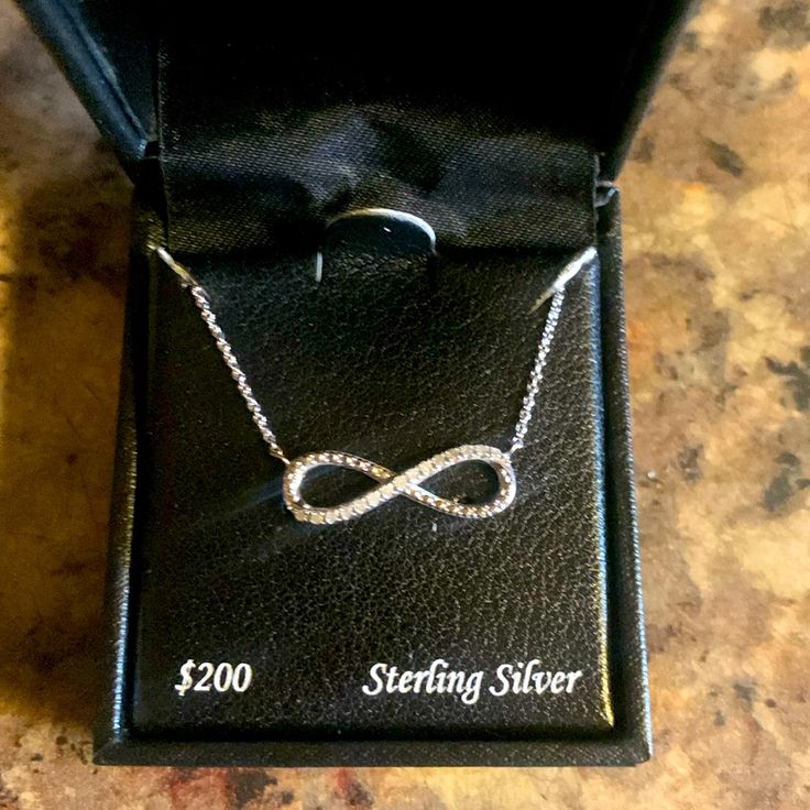 Brand New - Never Worn (No Tarnishing, Discoloration Or Defects Whatsoever) 10ct Diamond Infinity Charm Necklace On A Sterling Silver Dainty Chain This Is So Gorgeous! % Authentic Sterling Silver Infinity Necklace In White Gold, Classic Infinity Jewelry In Diamond White, Elegant Sterling Silver Diamond Necklace For Anniversary, Elegant Infinity Necklace In Diamond White, Classic Diamond White Infinity Jewelry, Classic Infinity-shaped Diamond White Jewelry, Infinity Jewelry With Diamond Accents For Gift, Diamond Infinity Necklace For Gift, Infinity Jewelry With Diamond Accents For Formal Occasions