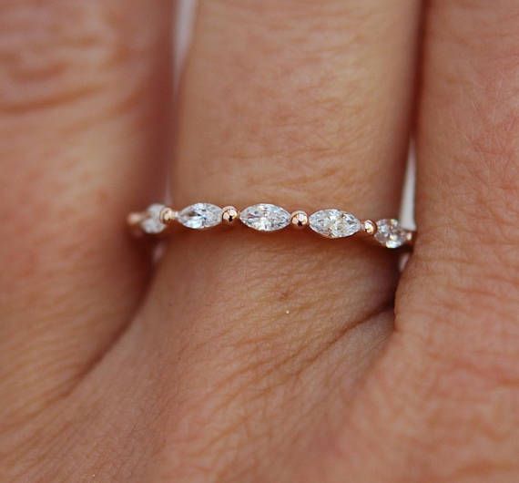 a woman's hand with a diamond ring on it