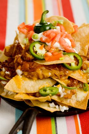 a stack of nachos sitting on top of a plate