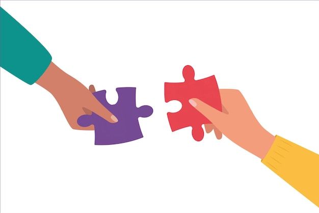 two hands holding pieces of a puzzle together