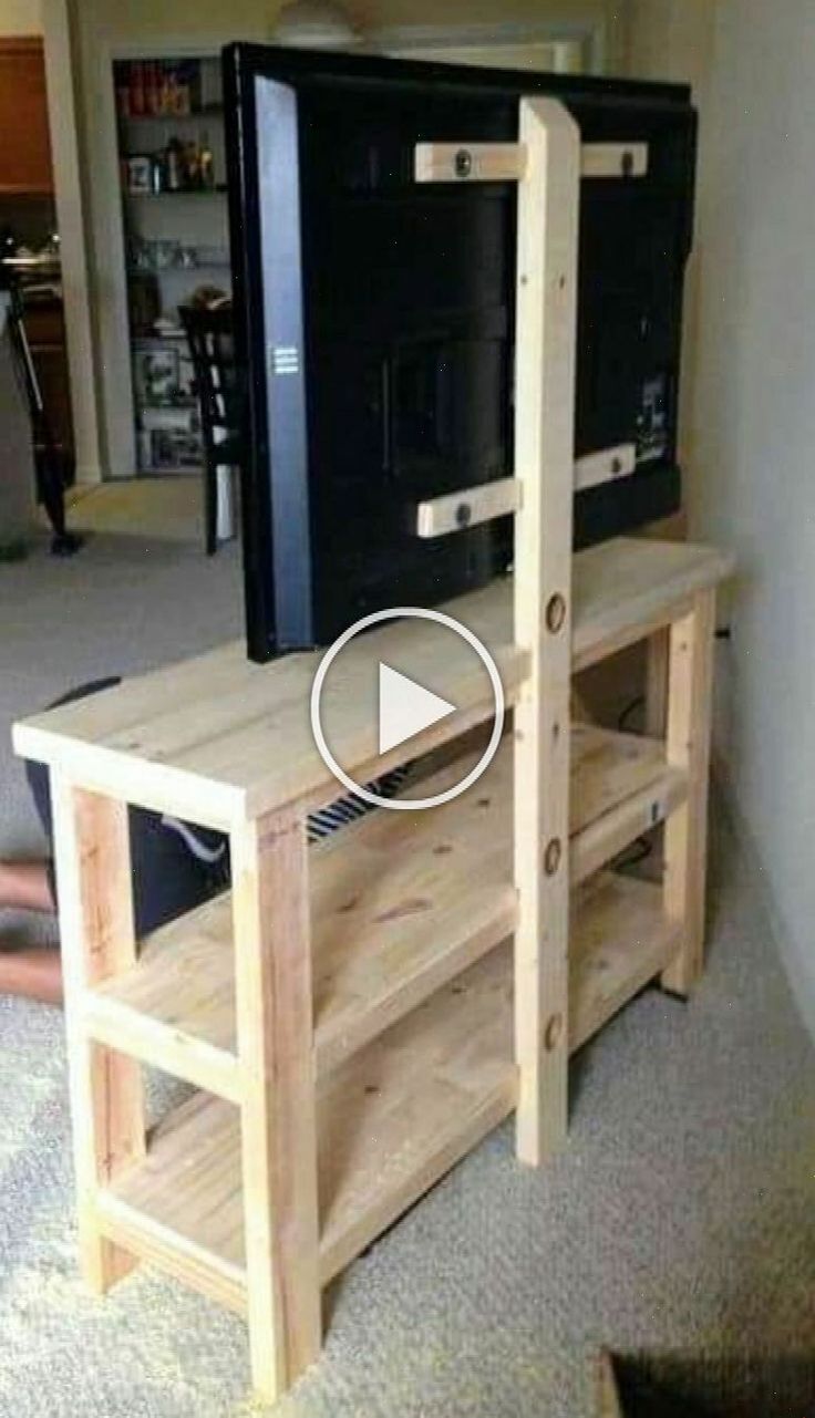 a small tv stand made out of wood with a shelf underneath it and a television on top