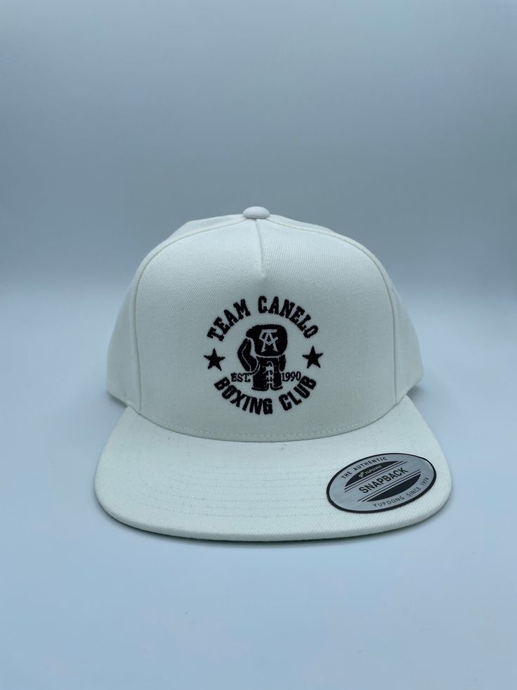 Yupoong adjustable SnapBack white hat . White Embroidered Logo Hat One Size, White Cotton Flat Bill Hat, White Trucker Hat With Embroidered Logo And Flat Bill, White Trucker Hat With Embroidered Logo, White Trucker Hat With Embroidered Logo Flat Bill, White Trucker Hat With Embroidered Logo And Curved Brim, White Flat Bill Trucker Hat With Embroidered Logo, White Snapback Hat One Size, White Cap With Embroidered Logo