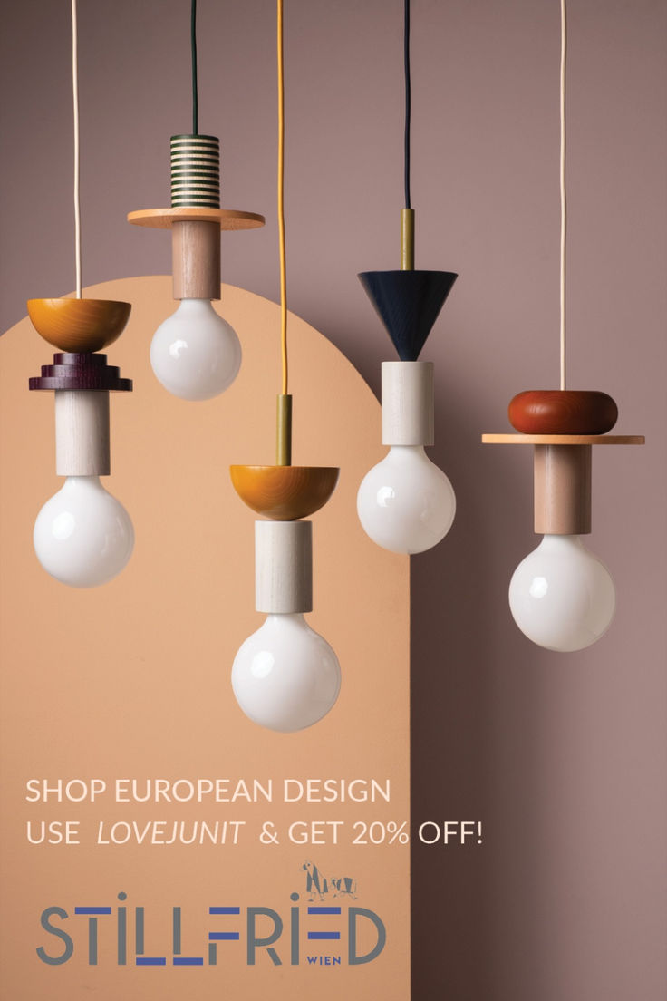 several light bulbs hanging from the ceiling in various shapes and sizes, with one bulb turned upside down