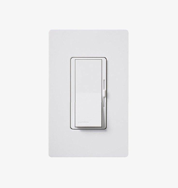 a white light switch sitting on top of a wall