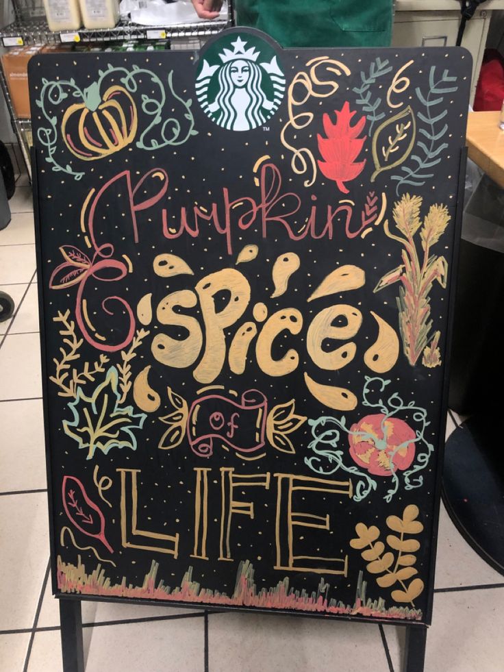 starbuck chalkboard “pumpkin spice of life” autumn themed with pumpkins, wheat, leaves, and swirls Starbucks Fall Board, Fall Chalkboard Art Starbucks, Fall Cafe Chalkboard, Fall Menu Board Ideas, Fall Menu Board, Pumpkin Chalk Art, Pumpkin Spice Chalkboard Art, Coffee Shop Boards Chalkboards, Coffee Chalkboard Ideas