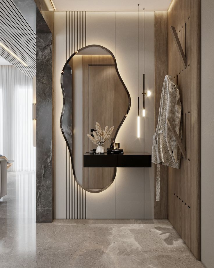 a modern bathroom with marble flooring and white walls, along with an oval mirror on the wall