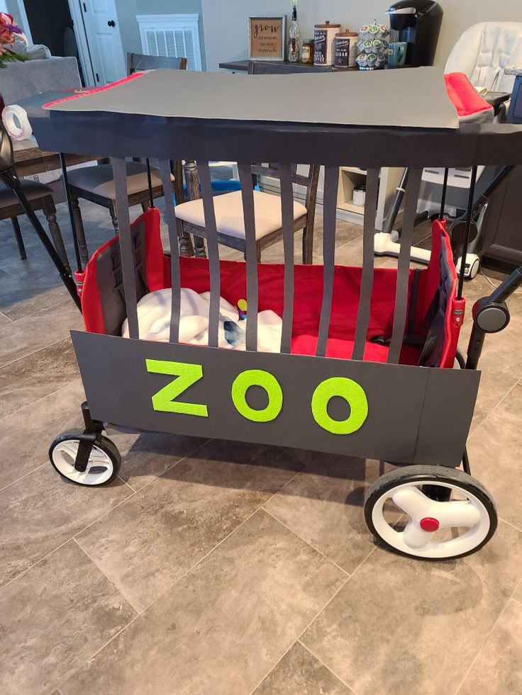 a baby crib with the word zoo written on it's side and wheels