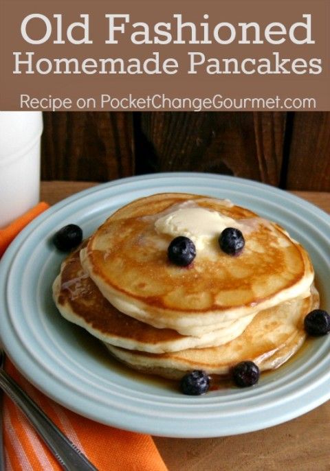 a stack of pancakes on a plate with blueberries