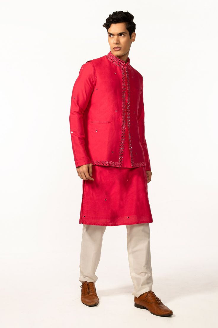 Hot pink bam silk kurta with mirror embroidery. Comes with ivory cotton silk pyjama pant and a bundi with welt pockets.
Components: 3
Pattern: Hand embroidered
Type Of Work: Mirror
Neckline: Mandarin collar
Sleeve Type: Bundi : Sleeveless, Kurta : Full
Fabric: Kurta and Bundi : Bam silk, Pant : Cotton silk
Color: Pink
Other Details: 
Side slits on kurta
Closure : Front buttons
Occasion: Mehendi and Haldi, Sangeet - Aza Fashions Sleeveless Kurta, Silk Pajama Pants, Pink Kurta, Mirror Embroidery, Silk Pant, Silk Kurta, Pink Mirror, Nehru Jackets, Pajama Pant