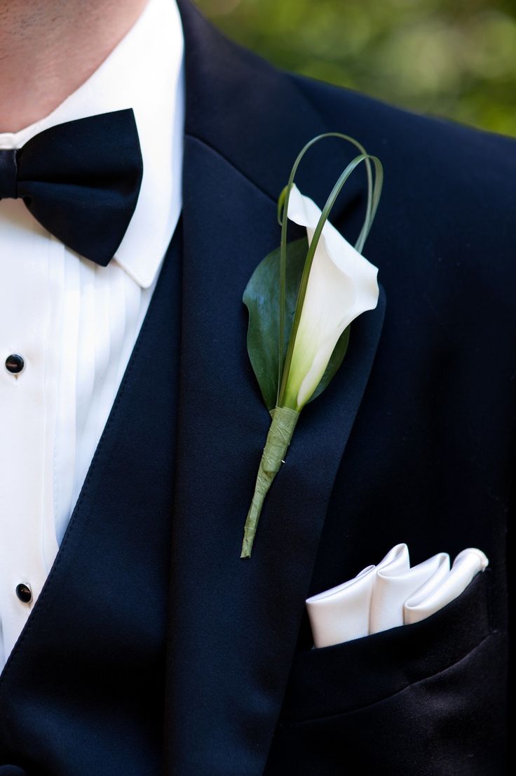 a man in a tuxedo with a boutonniere on his lapel