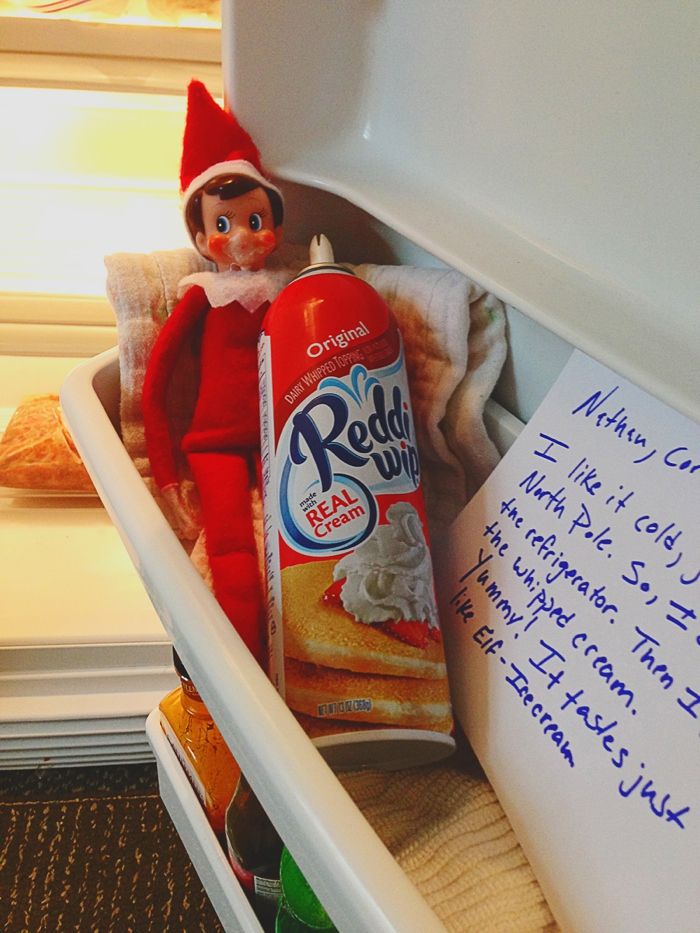 the elf is in the refrigerator with his handwritten letter to santa claus on christmas morning