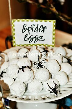 spider eggs on a white plate with green and black decorations