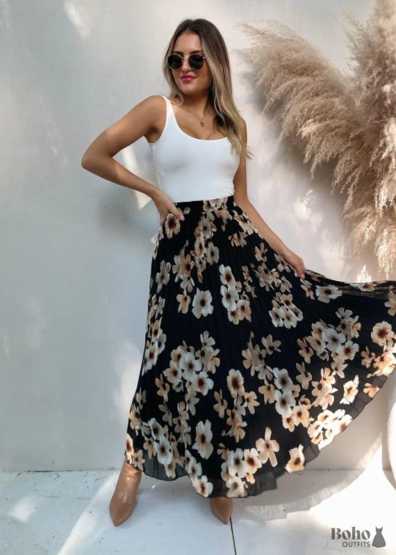 This flirty black dress is perfect for a boho-inspired look. The loose, flowy silhouette and delicate floral print make it ideal for summertime style. Pair with sandals or wedges and statement jewelry to complete the ensemble. This versatile piece can be dressed up or down depending on your mood and occasion. You'll love the freedom of movement afforded by the comfortable fabric blend, making this an essential addition to your wardrobe. Summer Flowy Chiffon Sundress, Spring Floral Chiffon Dress For The Beach, Spring Beach Floral Chiffon Dress, Flowy Floral Maxi Dress For Day Out, Black Floral Maxi Dress For Beach Season, Black Floral Print Maxi Dress For Beach Season, Casual Boho Print Floral Dress, Casual Floral Dress With Boho Print, Chiffon Maxi Dress For Day Out In Summer