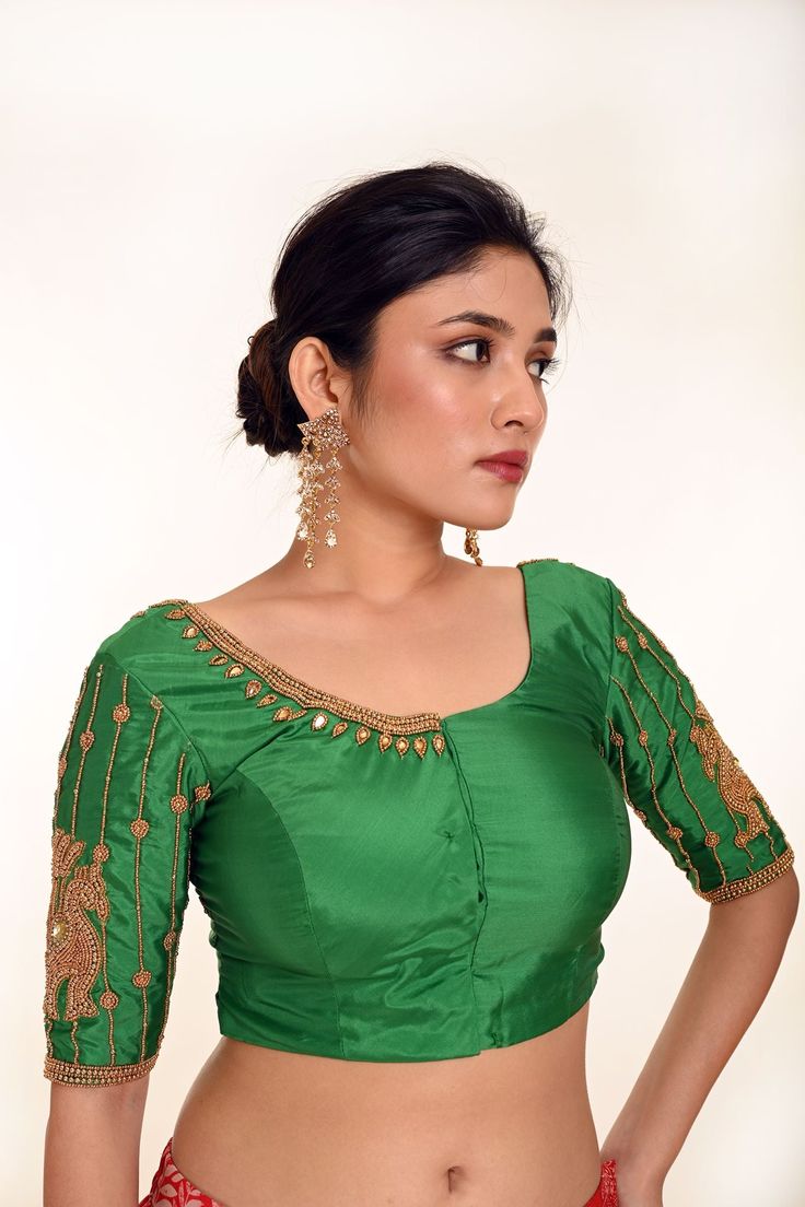 Introducing the Classic Green Aari Work Bridal Blouse in Pure Silk—a masterpiece of timeless beauty and craftsmanship. This stunning blouse, made from luxurious pure silk, is adorned with intricate Aari embroidery, adding a delicate and refined touch to its elegant design. The rich green color enhances its traditional appeal, making it an ideal choice for brides seeking both sophistication and grace. Perfectly suited for pairing with any bridal saree, this blouse will elevate your look and make your special day truly unforgettable. Readymade Saree, Ready To Wear Saree, Dupion Silk, Readymade Blouse, Blouse Online, Green Silk, Work Blouse, Embroidered Silk, Embroidered Blouse