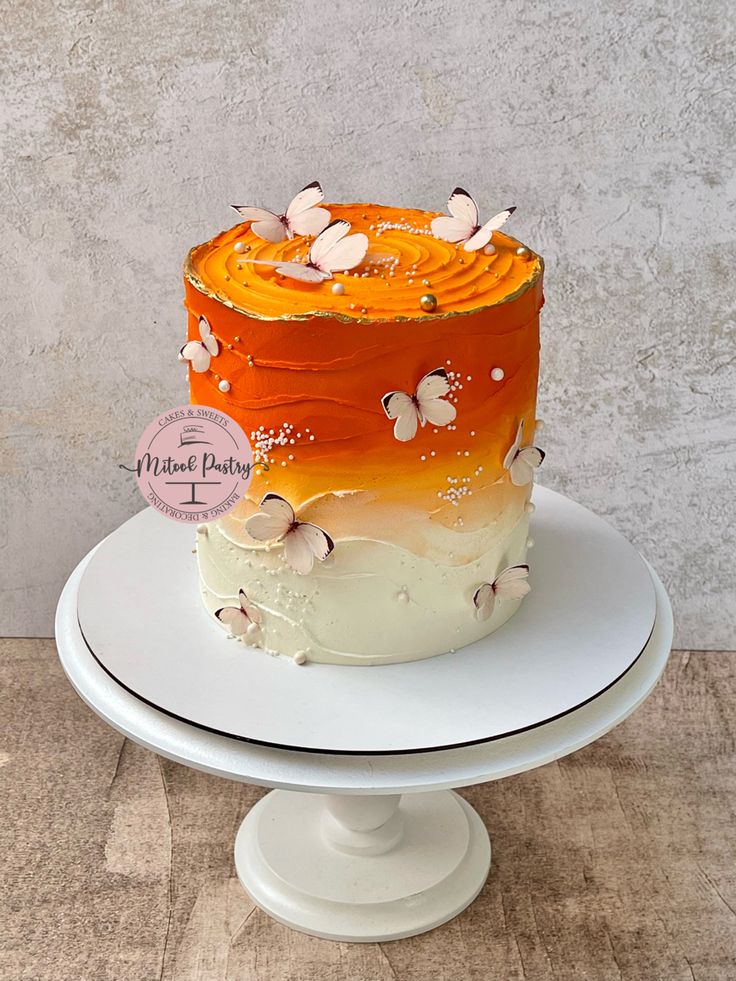 an orange and white cake sitting on top of a plate