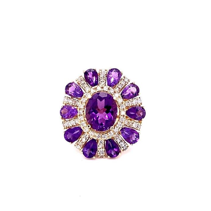 This ring has a Natural Oval Cut Amethyst that weighs 3.28 carats and Natural Pear Cut Amethysts that weigh 3.28 carats. It also has Natural Round Cut Diamonds that weigh 1.06 carats. The total carat weight of the ring is 8.28 carats. Curated in 14 Karat Yellow Gold. The ring is a size 7 and can be re-sized at no additional cost. Yellow Gold Cocktail Ring, Gold Cocktail Ring, Gold Cocktail, Pear Cut, Cocktail Ring, Round Cut Diamond, Jewelry Designs, Cocktail Rings, Free Jewelry