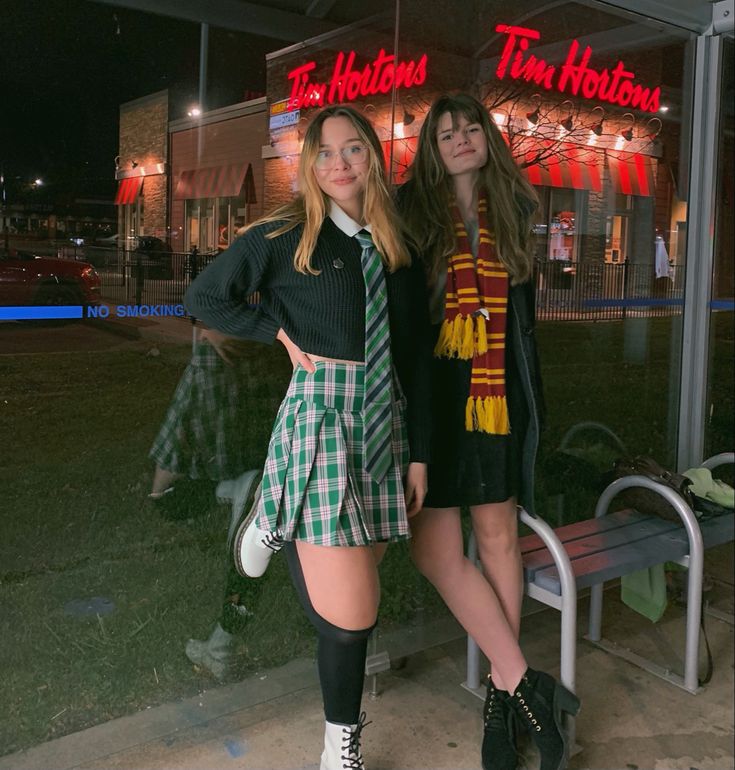 two girls standing next to each other in front of a store