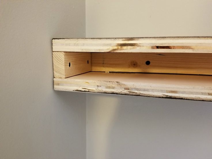 a wooden shelf with some holes in it