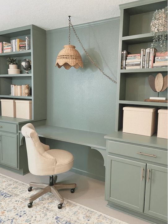 a chair and desk in a room with built - in bookshelves on the wall