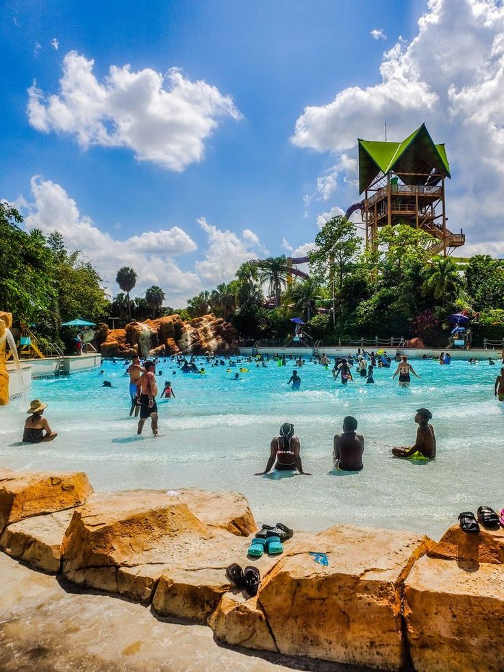 many people are in the water at an amusement park