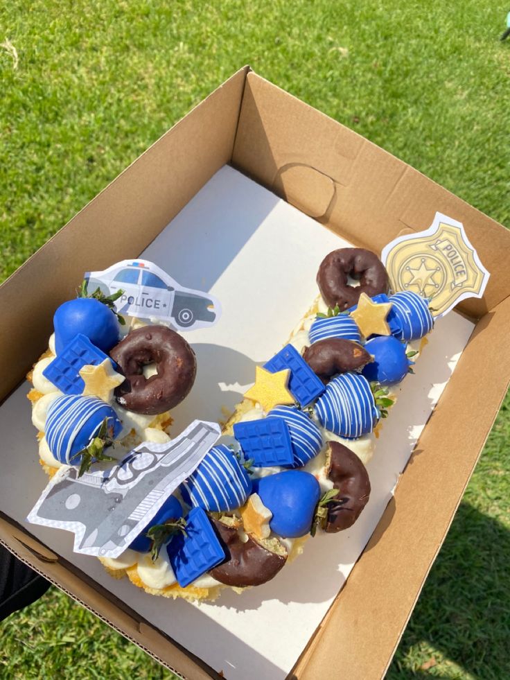 a box with some doughnuts in it on the grass