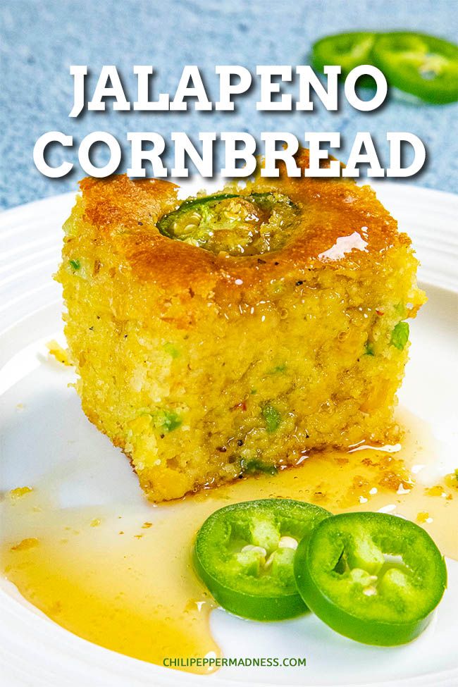 jalapeno cornbread on a white plate with some green peppers and sauce