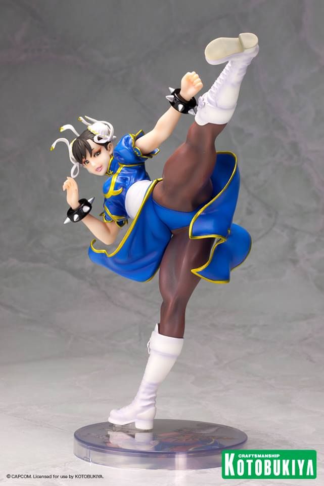 a figurine is posed on top of a stand with one leg in the air