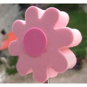 a pink flower shaped object on top of a pole