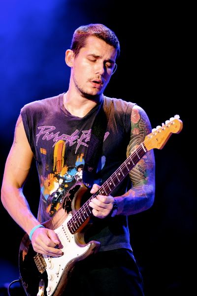 a man playing an electric guitar on stage