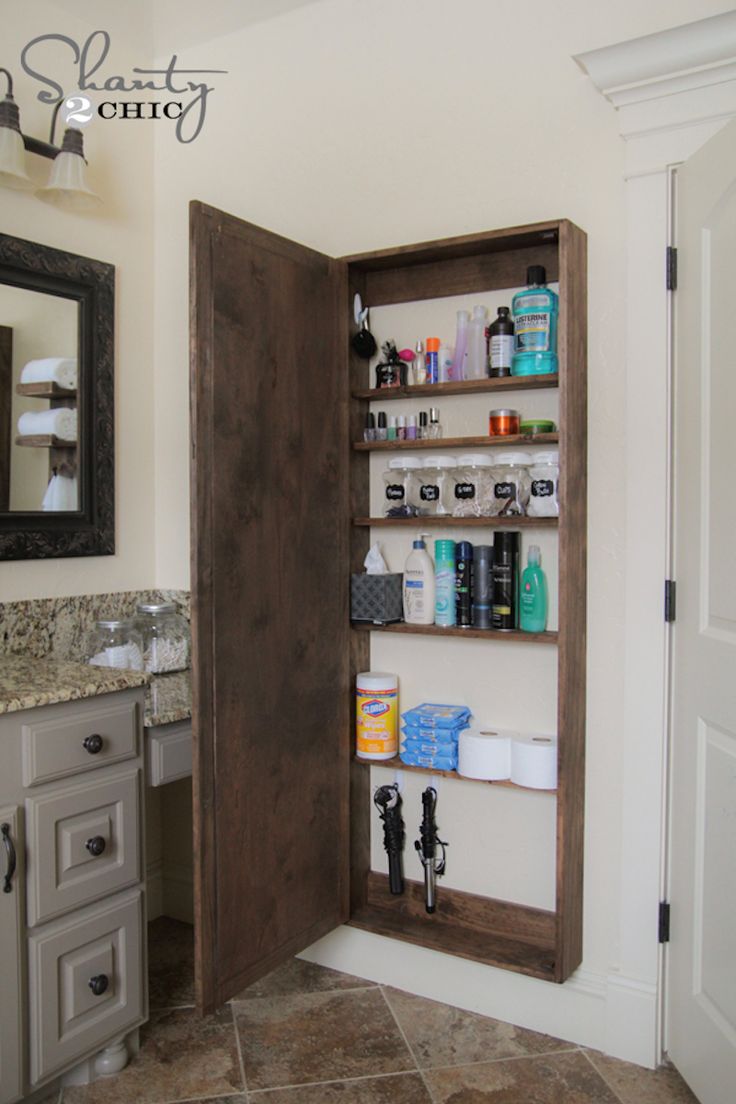 the bathroom storage cabinet is open to reveal its contents