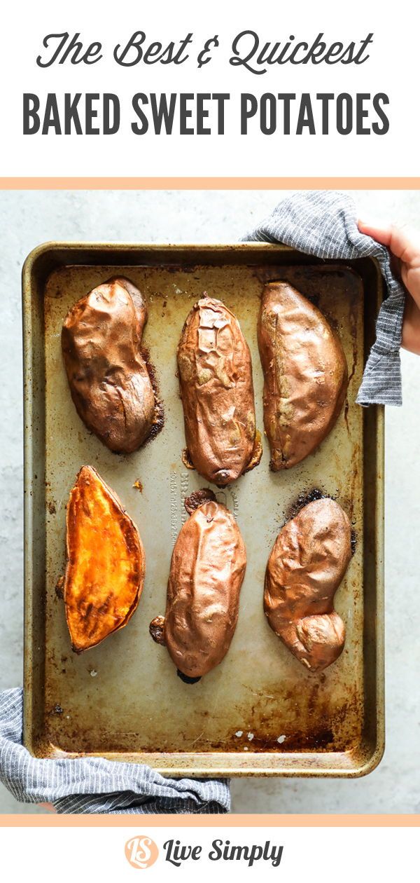 someone is holding a tray with baked potatoes on it and they are ready to be cooked