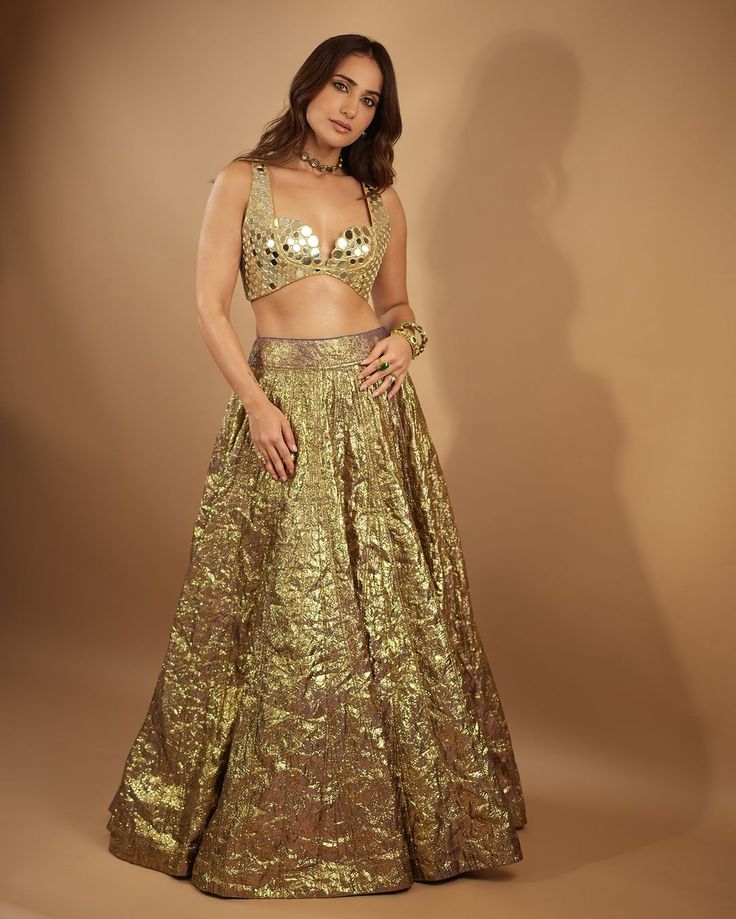 Introducing the Lampi lehenga set, a stunning ensemble that embodies timeless elegance and contemporary charm. The lehenga features intricate mirror work, meticulously handcrafted to accentuate its rich texture and vibrant hues. Paired with a matching mirror-embellished blouse and complemented by a mirror dupatta, this ensemble exudes grace and sophistication, perfect for any special occasion or celebration. Kusha Kapila, Mirror Dupatta, Ambani Wedding, Intricate Mirror, Golden Lehenga, Gold Lehenga, Mirror Work Lehenga, Padded Blouse, Embellished Blouse