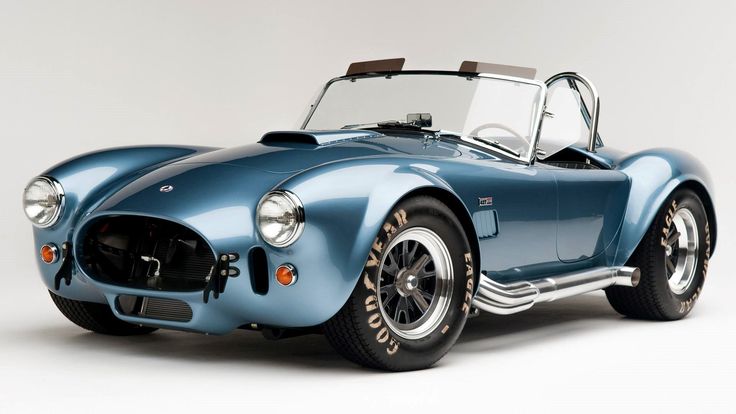 an old blue sports car is shown in this image